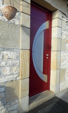 Modèle ATLANTIDE colori rouge satiné (RAL 3004) - décor rainuré avec parement inox brossé et vitrage organique blanc.